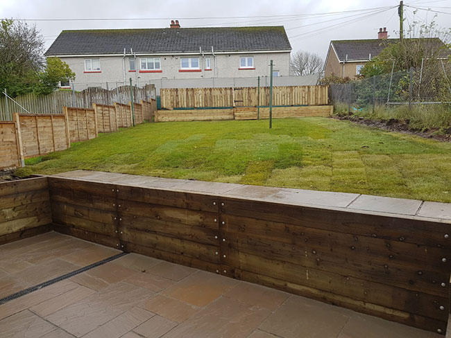 After photo of the garden with new fence, steps, gate and patio