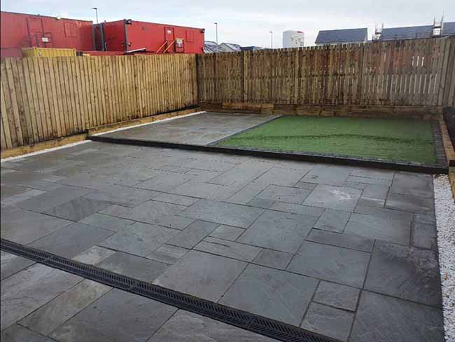 Grey multi-Indian sandstone paving and charcoal grey kerbstone
