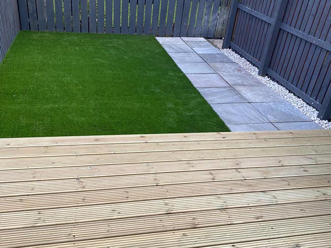 Timber decking leading up to Artificial Grass