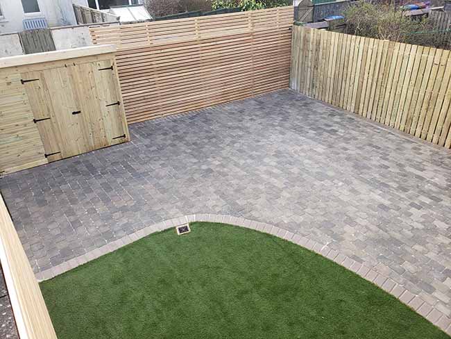 After photos of the Slate, tumbled tegula block paving with a natural pedesta border