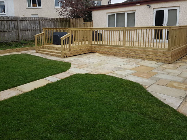 Artificial grass Glasgow showing decking and Indian Sandstone patio
