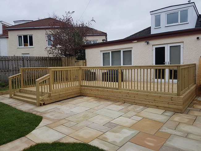 Artificial grass Glasgow showing decking and Indian Sandstone patio