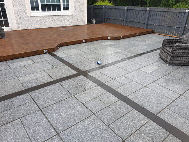 Granite slabs, various sizes, with tobermore shannon charcoal block dividers creating this stunning look 