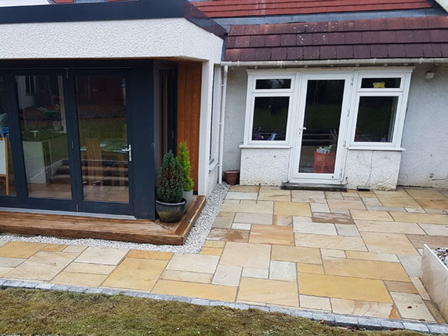 Indian sandstone garden patio with fencing & retaining wall