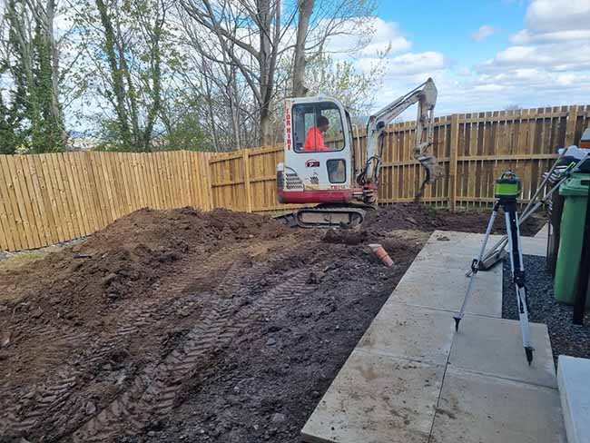 Before Photos: Digger brought in the clear the area for the new Patio completed in May 2023